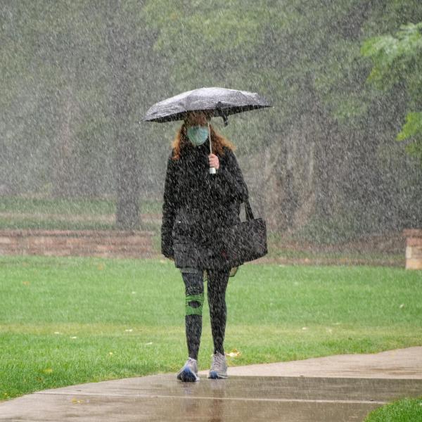 Students walk through the first snow of the fall 2020 semester on the CU Boulder campus. (Photo by Glenn Asakawa/University of Colorado)