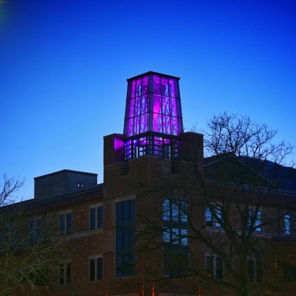 On March 5, the Roser ATLAS building shines magenta––part of the state of Colorado's COVID-19 anniversary remembrance. (Photo by Glenn Asakawa/CU Boulder)
