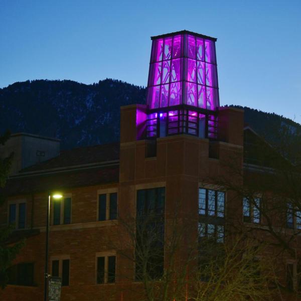 On March 5, the Roser ATLAS building shines magenta––part of the state of Colorado's COVID-19 anniversary remembrance. (Photo by Glenn Asakawa/CU Boulder)