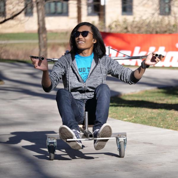 Shazwan Azri, a junior mechanical engineering major from Malaysia, rides his tri-bike during warm ups outside of the Idea Forge where the vehicles were constructed.