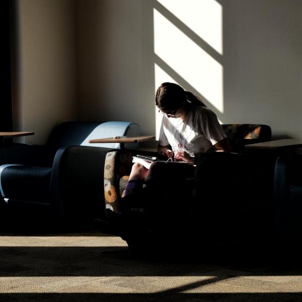 Katie Onorato, junior chemistry and classics major, finds a sunny spot to work in the Eaton Humanities building. Photo by Glenn Asakawa.