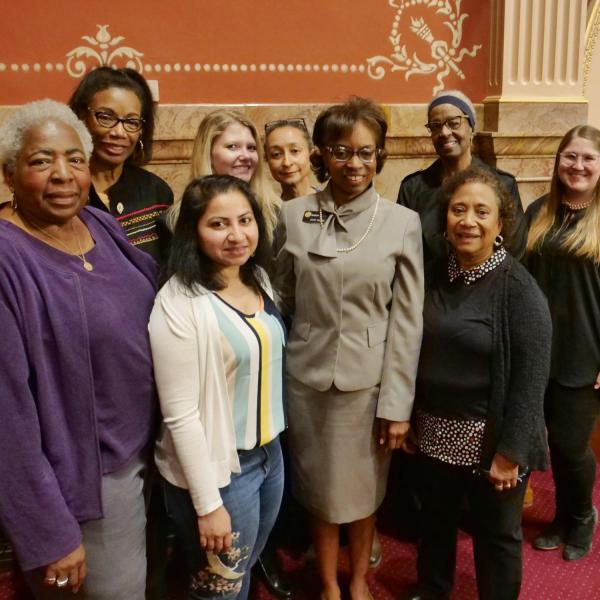 State Senator Rhonda Fields, standing next to CU faculty member Polly McLean, and other friends and genealogists pose for a group photo.