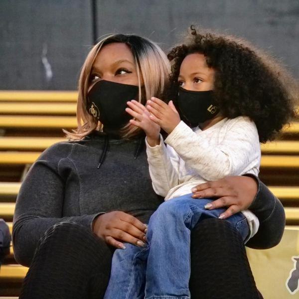 Tyanna Shenault, with her son Elijah, 4, right, watches the Colorado-UCLA football game on Saturday, Nov. 7, 2020. (Photo by Glenn Asakawa/University of Colorado)