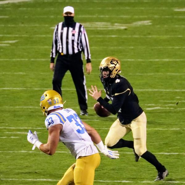 Colorado quarterback Sam Noyer scrambles during a first-half play against UCLA. (Photo by Glenn Asakawa/University of Colorado)