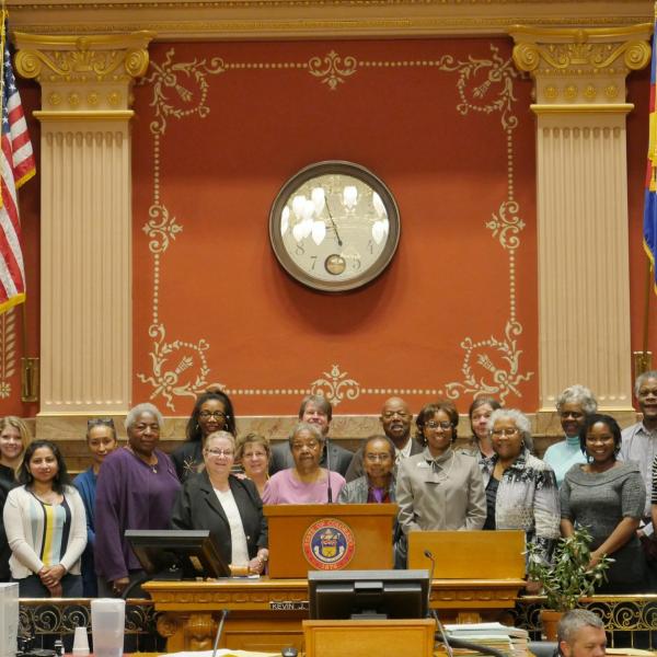 State Senator Rhonda Fields, flanked by CU Boulder leaders Alphonse Keasley and Patty Limerick, pose for a group photo in the senate chamber.