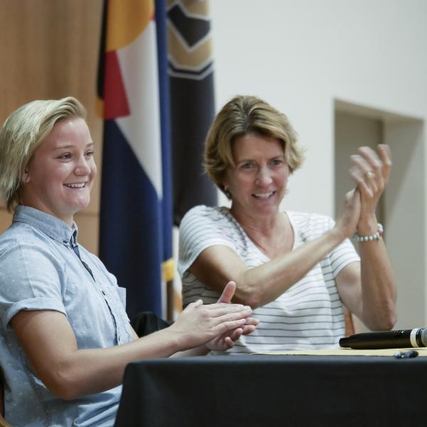 Panelists applaud a point in the discussion