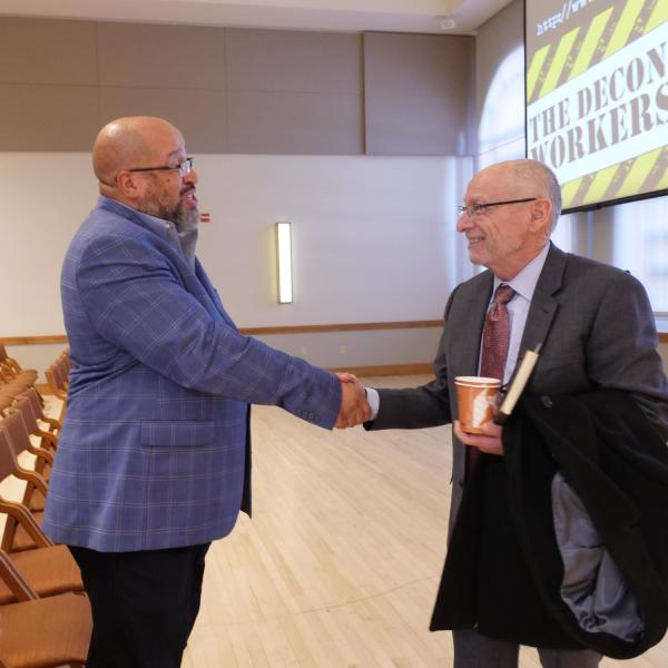 Dr. Christopher Bell, left, shakes hands with Provost Russell Moore, right, following the keynote address for the 2019 Fall Diversity Summit. (Photo by Glenn Asakawa/University of Colorado)