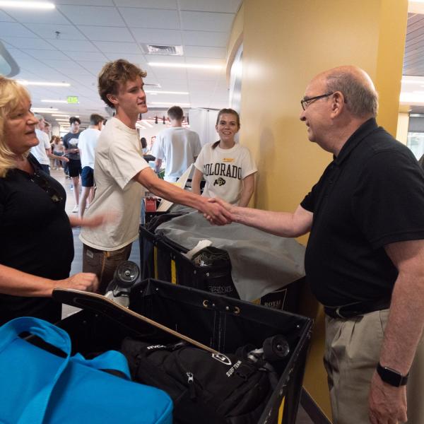 Ben Cunningham, first year business student from Orange County, California, greets Chancellor DiStefano as his mother, Kelli, looks on during move-in on Wednesday, Aug. 21, 2019, at Williams Village East. (Photo by Glenn Asakawa/University of Colorado)