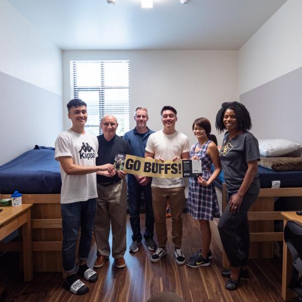 Chancellor Phil DiStefano, second from left, and Akirah Bradley, Associate Vice Chancellor for Student Affairs, pose with the Martin family during move-in on Wednesday, Aug. 21, 2019, at Williams Village East. (Photo by Glenn Asakawa/University of Colorado)