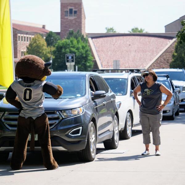 Christina Gonzales, Vice Chancellor for Student Affairs, right, tries to direct traffic in spite the clowning around from Chip during move-in on Tuesday, Aug. 20, 2019, at Baker Hall. (Photo by Glenn Asakawa/University of Colorado)