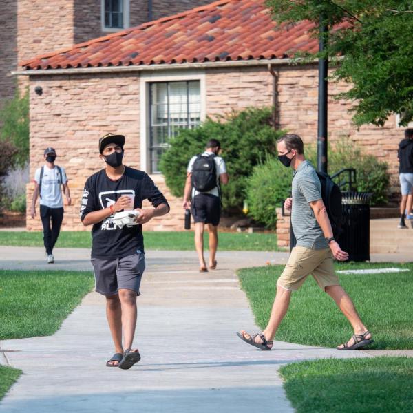 Students, staff and faculty, all wearing facial coverings and practicing proper social distancing protocols, participate in classes and study on the first day of the 2020 Fall semester on the CU Boulder Campus. (Photo by Glenn Asakawa/University of Colorado)