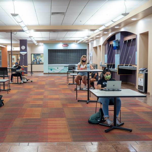 Students study inside the UMC, all wearing facial coverings and practicing proper social distancing protocols, on the first day of the 2020 Fall semester on the CU Boulder Campus. (Photo by Glenn Asakawa/University of Colorado)