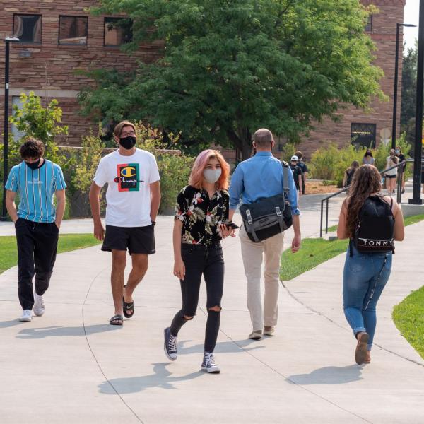 Students, staff and faculty, all wearing facial coverings and practicing proper social distancing protocols, participate in classes and study on the first day of the 2020 Fall semester on the CU Boulder Campus. (Photo by Glenn Asakawa/University of Colorado)
