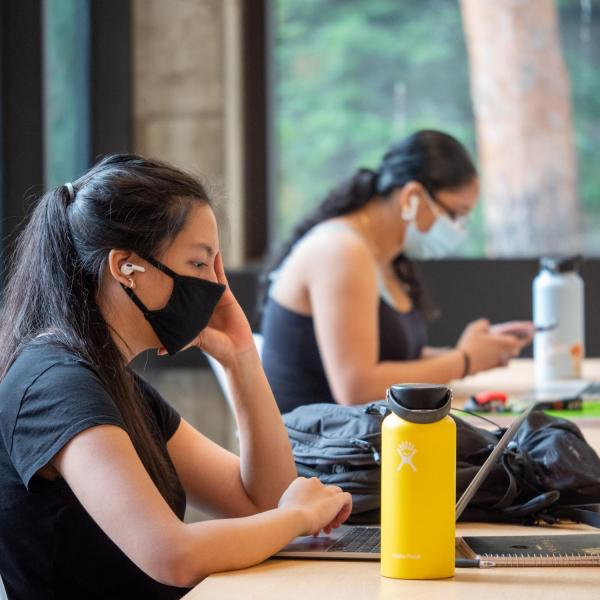 Students, staff and faculty, all wearing facial coverings and practicing proper social distancing protocols, study at the Engineering Center on the first day of the 2020 Fall semester on the CU Boulder Campus. (Photo by Glenn Asakawa/University of Colorado)