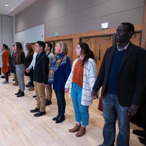 Participants hold hands and step forward or backward to illustrate differing backgrounds as Dyonne Bergeron, assistant vice chancellor for inclusion and student achievement, leads a collaborative discussion at her session titled “The Power of U In Community” at the CU Boulder 2020 Spring Diversity Summit. (Photo by Glenn Asakawa/University of Colorado)