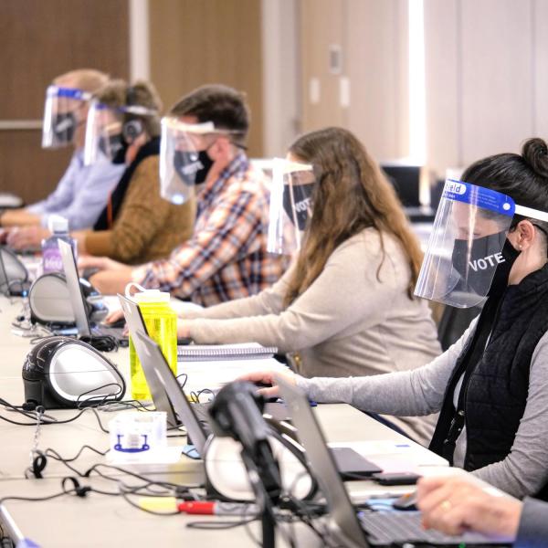 Election judges wear masks and face shields at the Williams Village Center polling center . (Photo by Glenn Asakawa/University of Colorado)