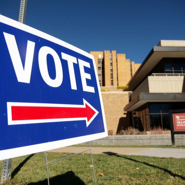 A "Vote" sign pointing to the Williams Village Center polling center. (Photo by Glenn Asakawa/University of Colorado)