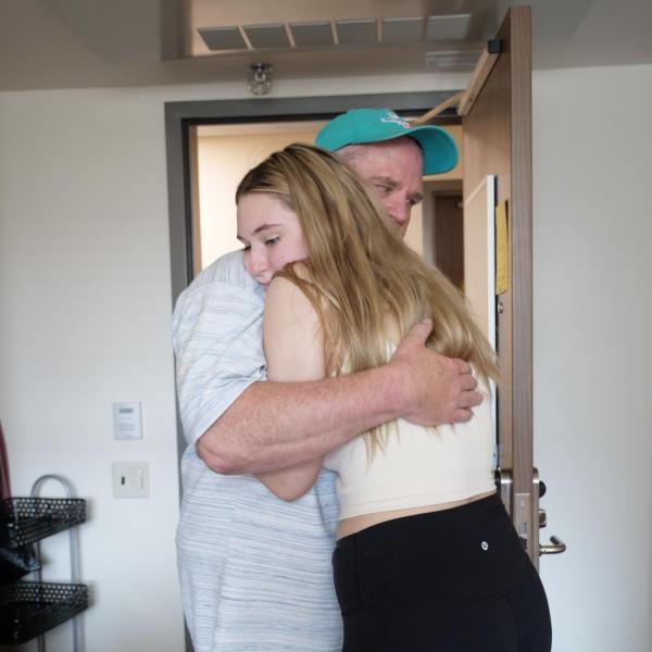 Ainslee Colgan, from Thornton, hugs her father, Jim, as she moves into Williams Village East residence hall on Monday, Aug. 16, 2021. (Photo by Glenn Asakawa/University of Colorado)