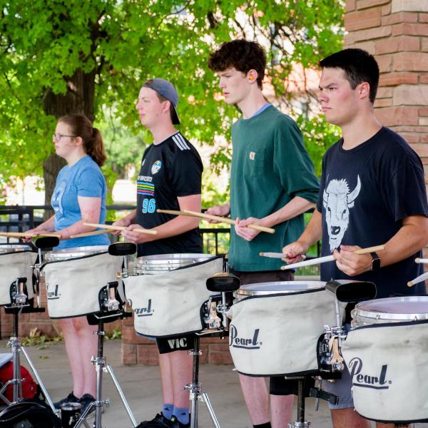 The Golden Buff Marching Band drum line practices at Farrand Field during Move-In on Tuesday, Aug. 17, 2021. (Photo by Glenn Asakawa/University of Colorado)