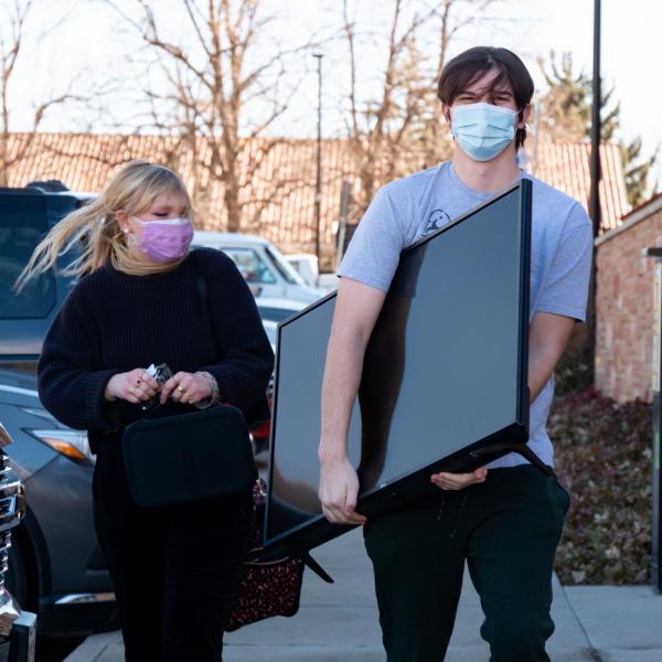 CU Boulder first year students Avery O’Neill, left, and Jackson Perrine return to the Kittredge Central residence hall on Feb. 7, 2021. (Photo by Glenn Asakawa/University of Colorado)