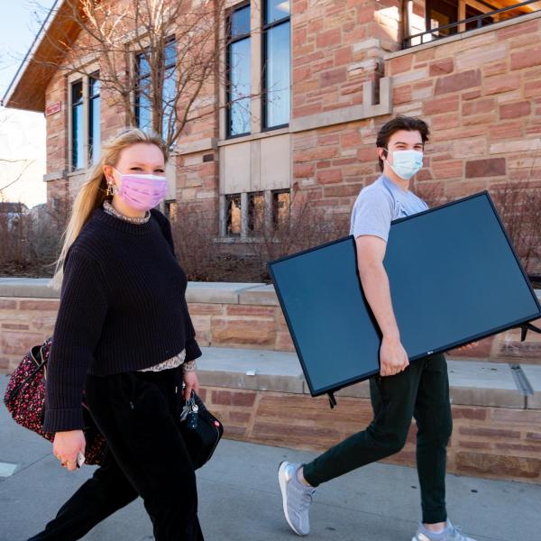 CU Boulder first year students Avery O’Neill, left, and Jackson Perrine return to the Kittredge Central residence hall on Feb. 7, 2021. (Photo by Glenn Asakawa/University of Colorado)
