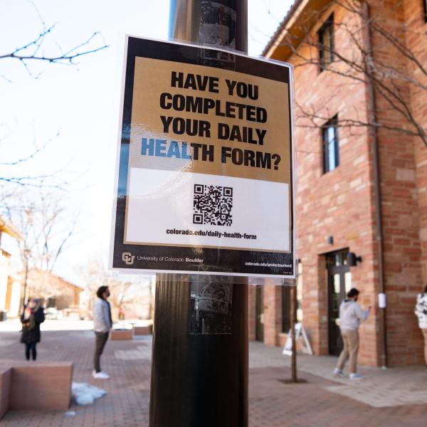 A COVID-19 monitoring station and signage near Kittredge Center on the CU Boulder campus. (Photo by Glenn Asakawa/University of Colorado)