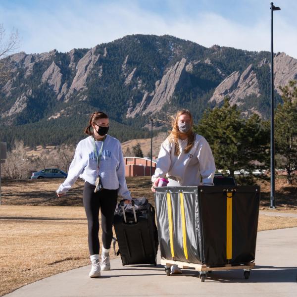 CU Boulder first year students Hailey Faith, left, and Charlotte Blish return to the Kittredge residence hall complex on Feb. 7, 2021. (Photo by Glenn Asakawa/University of Colorado)