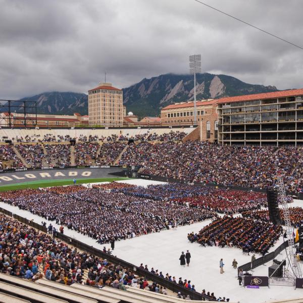 Commencement ceremony at Folsom Field with Flatirons in the background