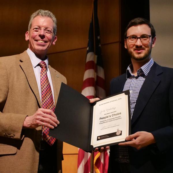 Javier Orjuela-Koop, right, is congratulated by Professor Bud Coleman for winning the people's choice award for the Three Minute Thesis Competition. Photo by Casey A. Cass.