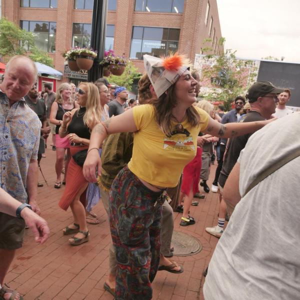People in the crowd dance to the music at Bands on the Bricks on Pearl Street