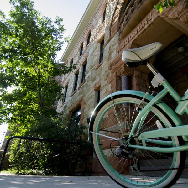 Teal cruiser bike parked on campus