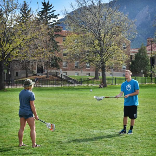 Students play lacrosse at Farrand Field