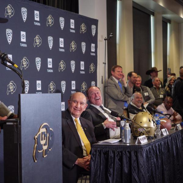 Sanders, left, makes Chancellor Phil DiStefano and Athletic Director Rick George burst out laughing during the press conference.
