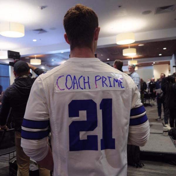 A guest dons a Cowboys jersey number worn by Sanders before the press conference announcing Coach Prime’s hiring.