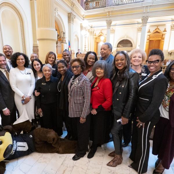 Deion Sanders, center in back row, poses with members of the Colorado Black Caucus lawmakers and CU leadership after a breakfast meeting at the Capitol