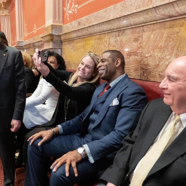 Mindy Miller, senior advisor to the Senate president, takes a selfie with Deion Sanders