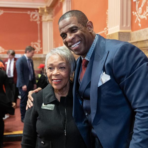 State Senator Janet Buckner takes a photo with Deion Sanders