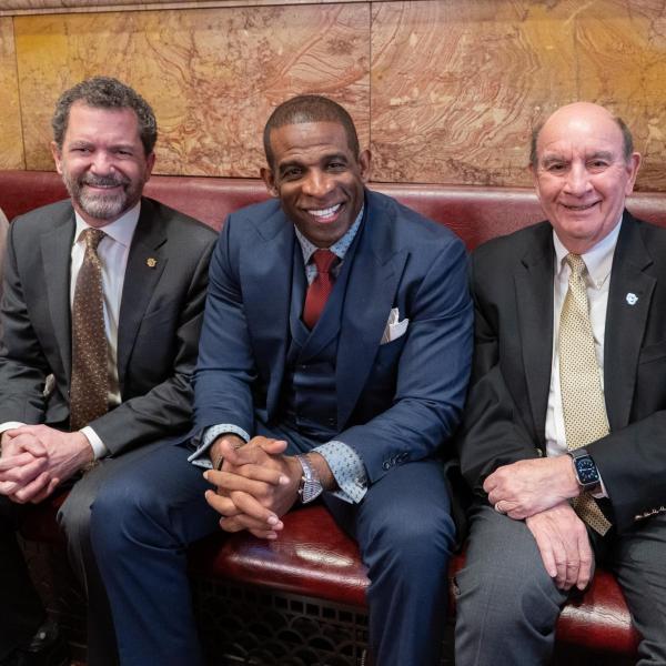 CU President Todd Saliman, CU head football coach Deion Sanders and CU Boulder Chancellor Phil DiStefano pose for a photo