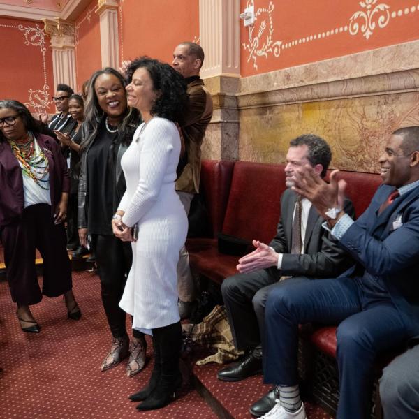 Deion Sanders, Todd Saliman and Phil DiStefano join in applause for recognition of CU Regent Wanda James being honored in the Senate Chamber
