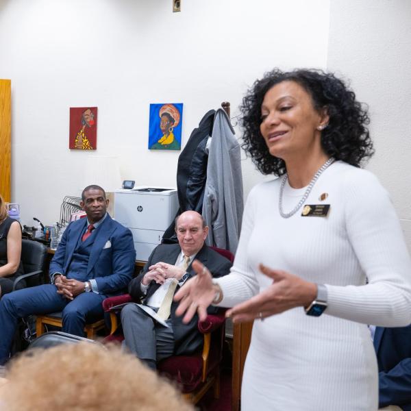 Deion Sanders and Chancellor Phil DiStefano listens to CU Regent Wanda James talk during a breakfast meeting of the Colorado Black Caucus lawmakers