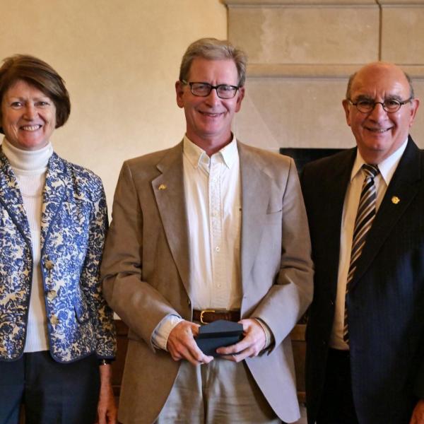 Professor Michael Dubson, center, is flanked by Chancellor Philip DiStefano and Ann Carlos, associate dean for social sciences, College of Arts and Sciences, during the 12th Annual Convocation Awards and Presentations Celebrating Faculty Achievements. (Photo by Casey A. Cass/University of Colorado)
