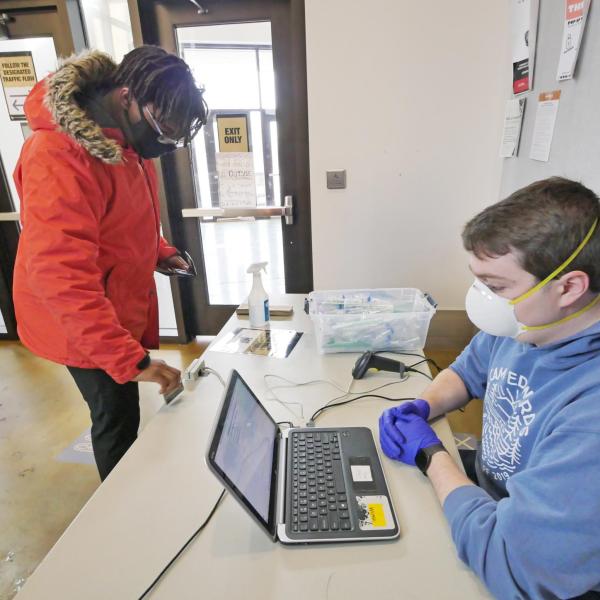 Allen Oden, a civil engineering major from Fort Bragg, North Carolina, takes a COVID-19 test at Williams Village at CU Boulder. (Photo by Casey A. Cass/University of Colorado)