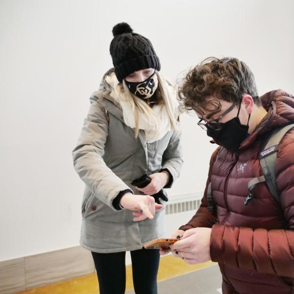 Lizzie Brister, with New Student and Family Services, directs Ethan Thompson, a computer engineering major from Parker, Colorado, where to go to take a COVID-19 test at Williams Village at CU Boulder. (Photo by Casey A. Cass/University of Colorado)
