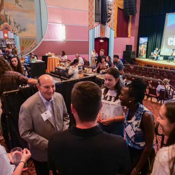 CU Boulder Chancellor Phil DiStefano, left, greets guests and students at the CU Night in Downtown Boulder event at Boulder Theater