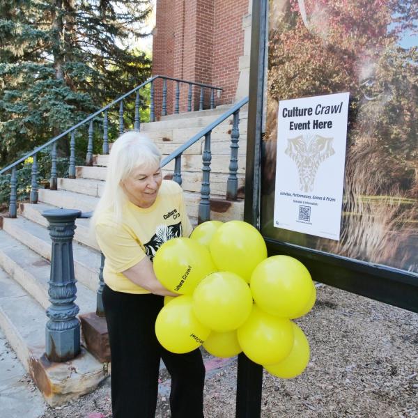 An employee displays yellow balloons outside one of the hotspots