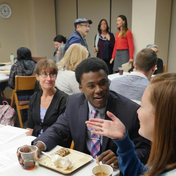 Attendees engage in lively conversation at the Summit