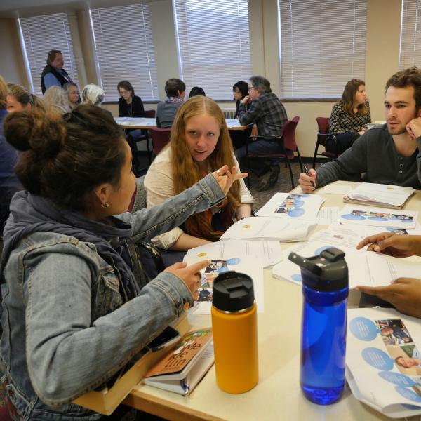 Attendees engage in lively conversation at the Summit