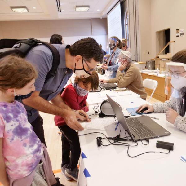 Boulderite Robert Gwizdala teaches democracy to his daughter, Magdalena, and son, Nico, both 7 years old, at CU Boulder’s University Memorial Center polling place. (Photo by Casey A. Cass/University of Colorado)