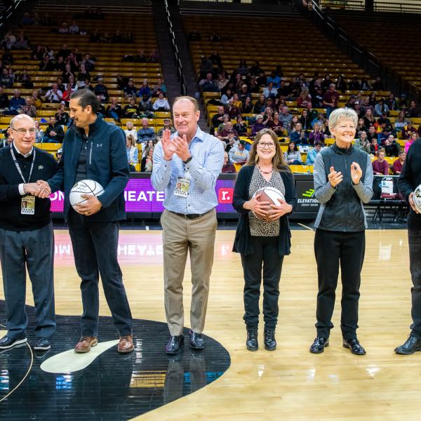 The four 2019 Chancellor’s Employee of the Year winners were honored during halftime of a recent Colorado basketball game. Left to right in this photo are: Jessie Kasynski, Chancellor Phillip DiStefano, J. Javier Portillo, Athletic Director Rick George, Melynda Slaughter, Ceal Barry and Alex Viggio. (Photo by Patrick Wine/University of Colorado)