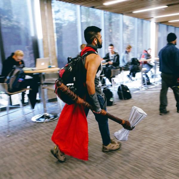 Student in a Halloween costume walks through the Engineering Center lobby. Photo by Glenn Asakawa.